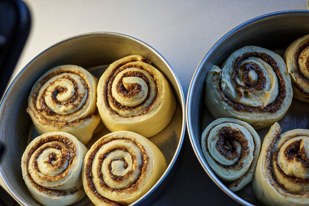 Soft Biscoff Cinnamon Rolls with Cream Cheese Frosting rolling dough